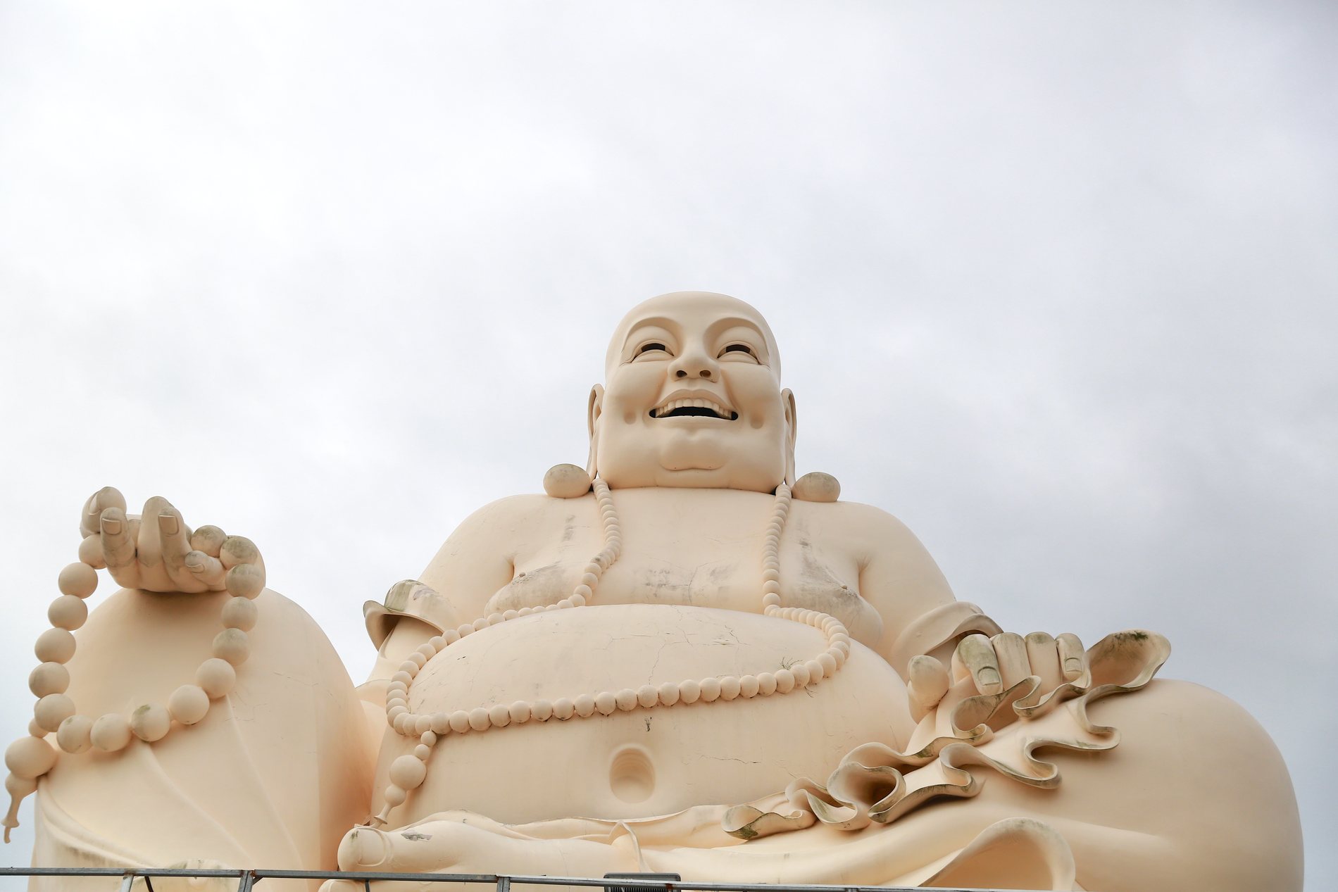 Large smiling Buddha statue at a Mekong region temple