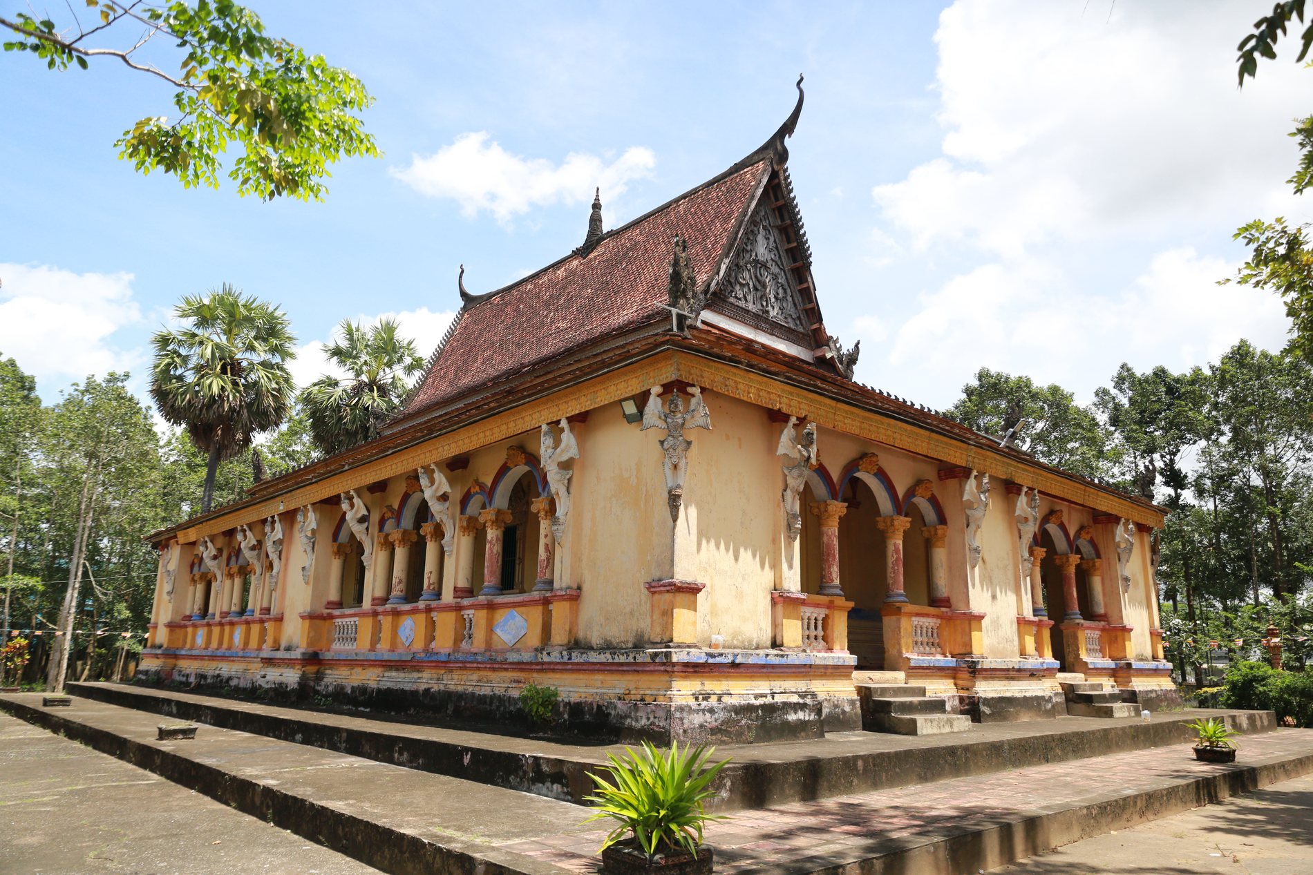 Khmer pagoda in southern Vietnam surrounded by palms and trees