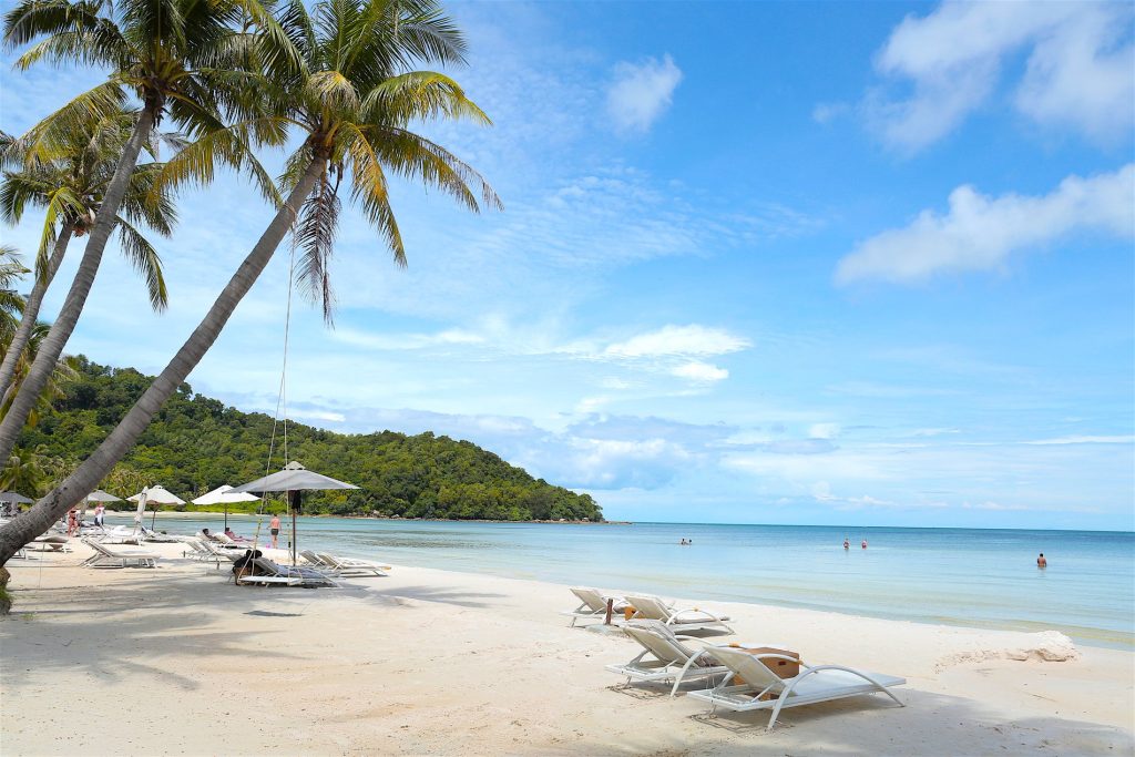 White sand beach, palms and clear blue water on Phú Quốc Island